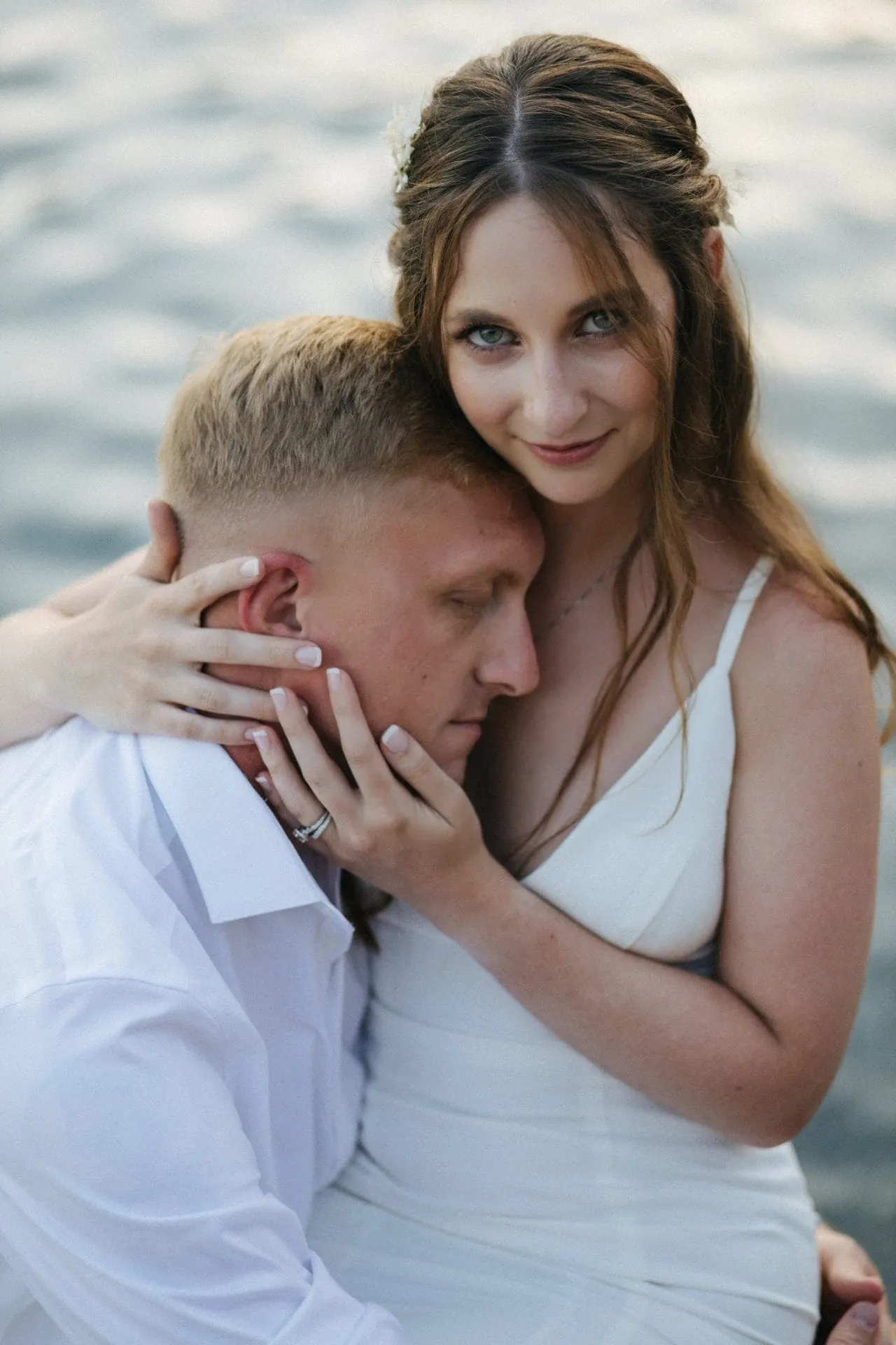 Bride embracing the groom by the water — Tyler & Leigha wedding gallery