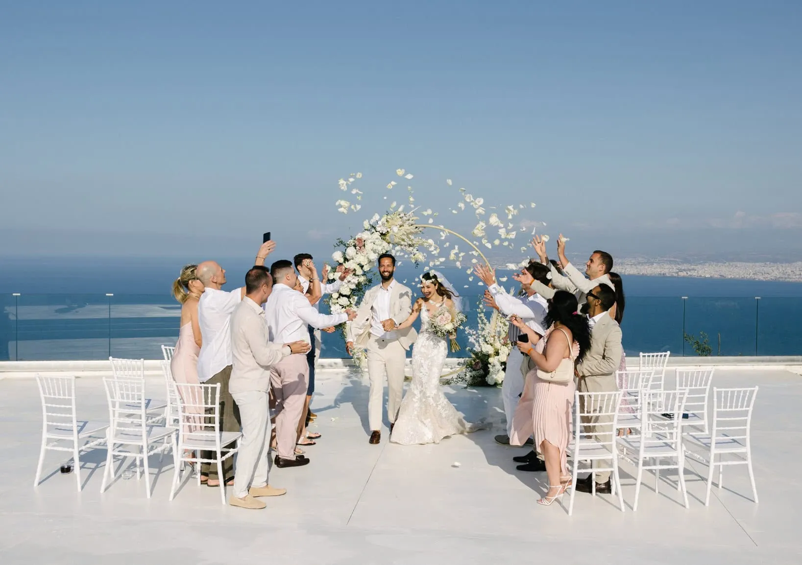 Wedding ceremony on a white terrace high above the Cretan sea